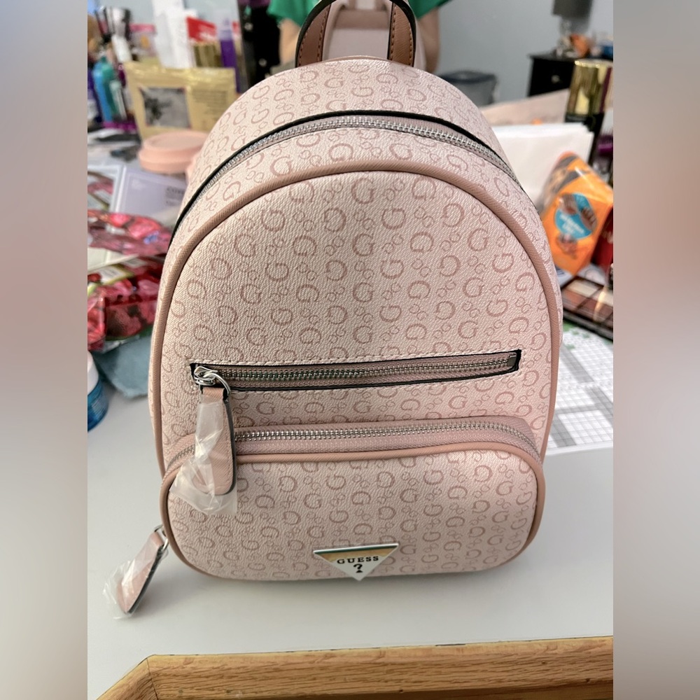 Small pink Guess backpack.